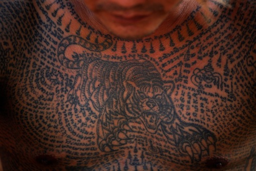 A devotee with a tiger tattoo attends the annual Magic Tattoo Festival at Wat Bang Phra in Nakhon Prathom province