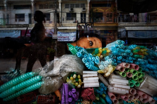 The head of a mannequin is left in the window of a beauty saloon in area where garment factories are based in one of Phnom Penh's suburbs