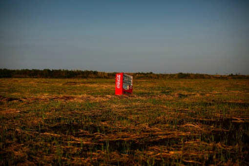 A vending machine, brought inland by a tsunami is seen in a abandoned rice field inside the exclusion zone at the coastal area near Minamisoma in Fukushima prefecture