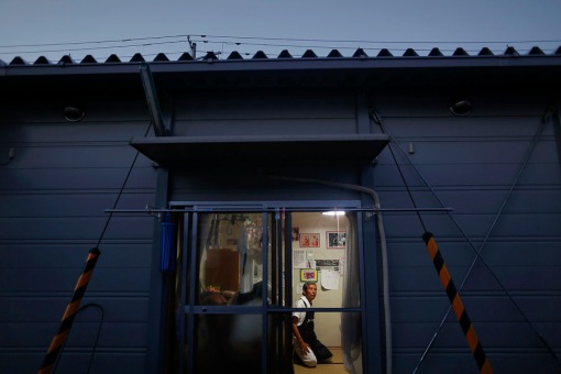 Hiroshi Maskura from the town of Tomioka near the tsunami-crippled Daiichi nuclear power plant sits inside his pre-fabricated house at the center for evacuees where he lives in Iwaki n Fukushima prefecture