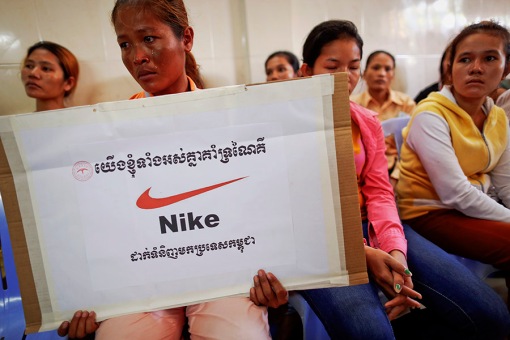 Som Cheantha, a eight month pregnant garment worker cries and holds a sign during a gathering of workers at their union headquarters in Phnom Penh