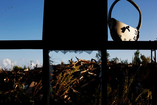A twisted clock, spider's webs and debris are seen from inside damaged primary school at the tsunami destroyed coastal area of the evacuated town of Namie in Fukushima prefecture only some 6 kilometers from crippled Daiichi power plant