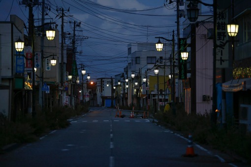 Street lamps light the street in the evacuated town of Namie in Fukushima prefecture