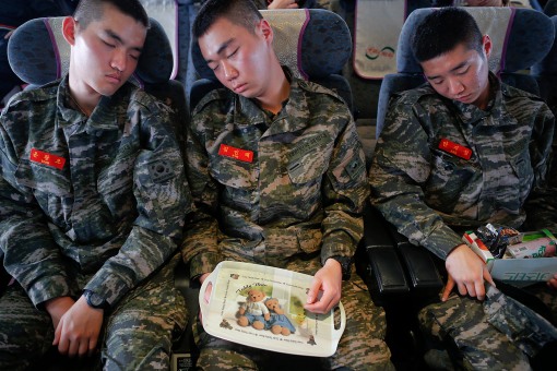 South Korean marines sleep on the ferry traveling to the mainland from the Yeonpyeong island that lays just inside the South Korean side of the Northern Limit Line (NLL) in Yellow Sea