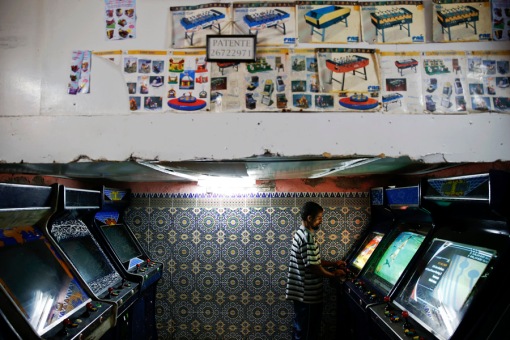 A man plays video games in an entertainment salloon in Rabat's Medina