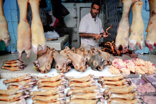 A butcher sells animal's legs and heads in Medina, Rabat's old city